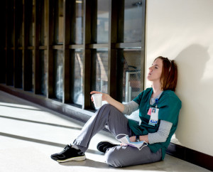 Exhausted nurse sitting on the floor