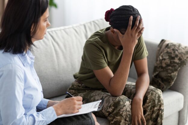 Woman veteran experiencing veteran trauma during therapist session in Utah