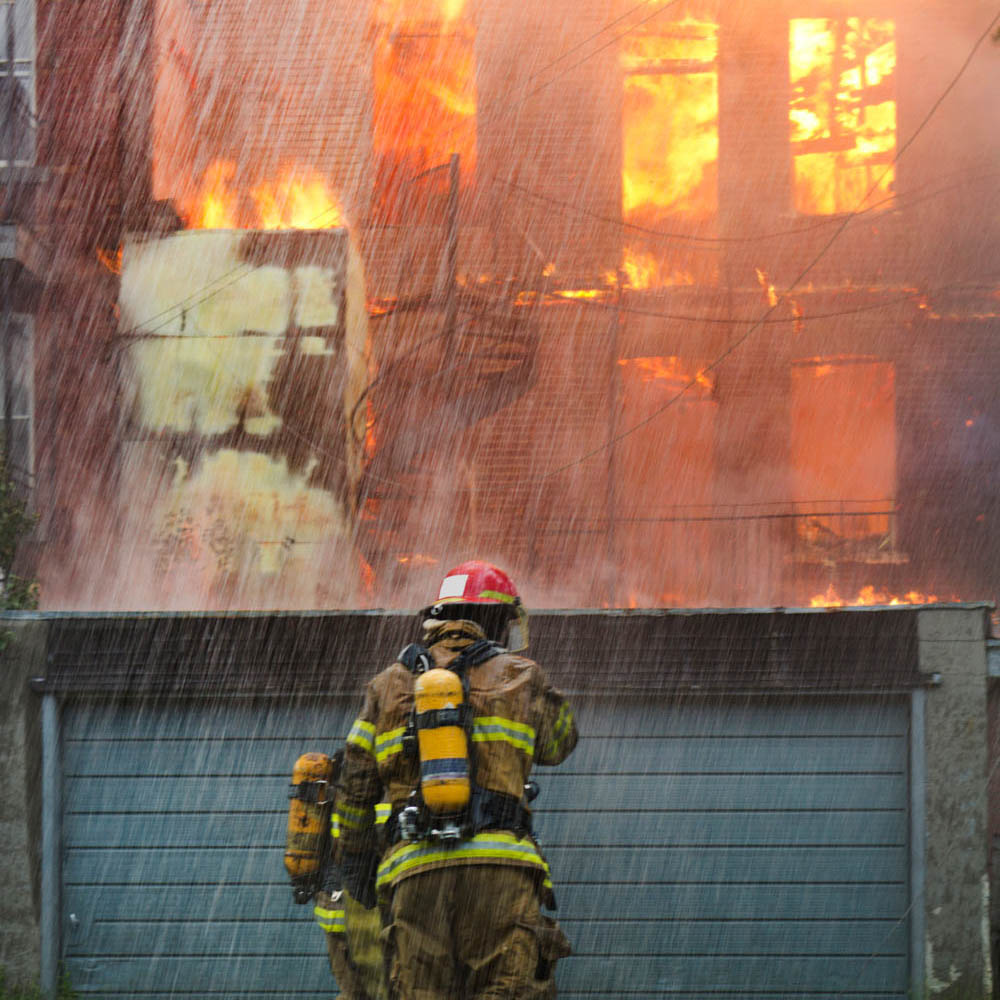 Firefighters rushing into a burning apartment building to rescue people, a heroic yet traumatic experience that often leads to PTSD and addiction. Deer Hollow specializes in treating first responders by addressing their unresolved trauma and addiction for lasting recovery."" ""Firefighters rushing into a burning apartment building to rescue people, a heroic yet traumatic experience that often leads to PTSD and addiction. Deer Hollow specializes in treating first responders by addressing their unresolved trauma and addiction for lasting recovery.